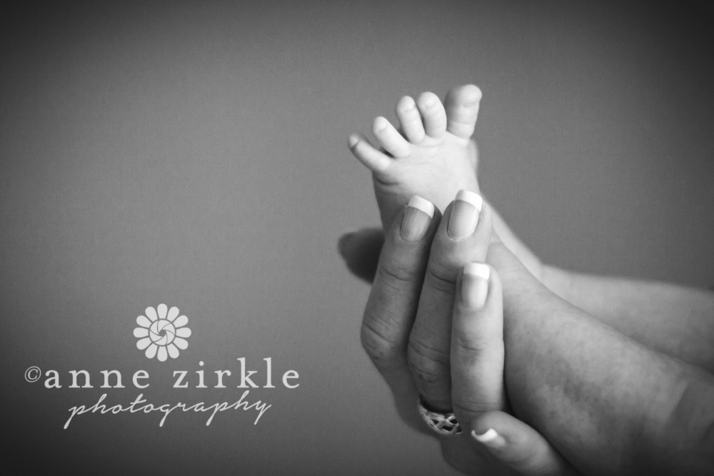 newborn foot with toes spread in moms hand Mooresville and Lake Norman newborn baby photographer