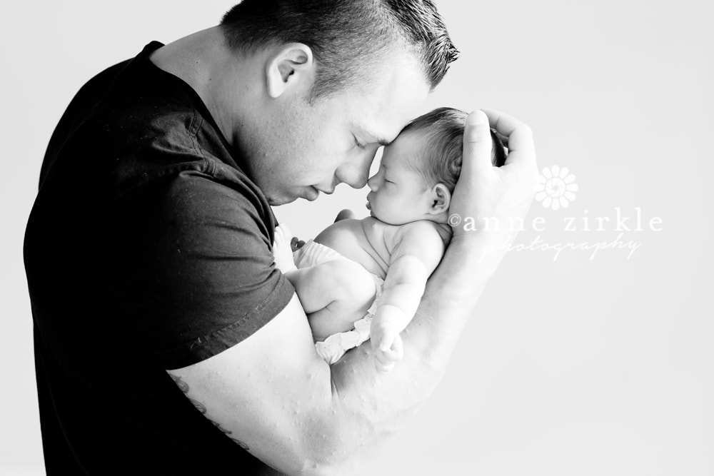 newborn girl held by dad Mooresville and Lake Norman newborn baby photographer