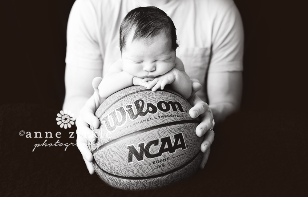 newborn on basketball with dad's hands Mooresville and Lake Norman newborn baby photographer