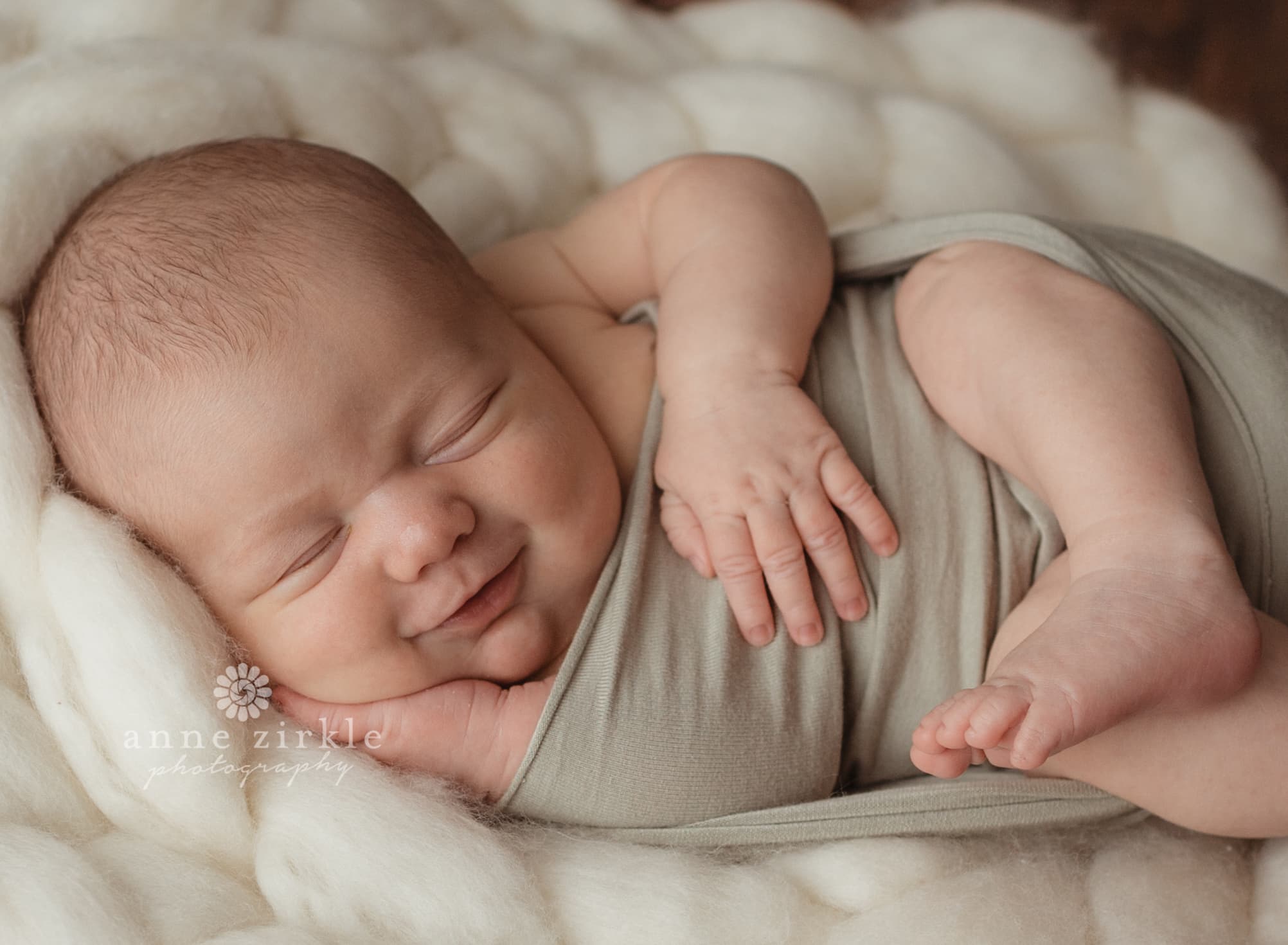 newborn smiling and swaddled Mooresville and Lake Norman newborn baby photographer